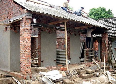 Workers building a house for low income group of people Workers building a house for low income group of people